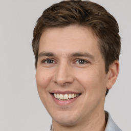 Joyful white adult male with short  brown hair and brown eyes