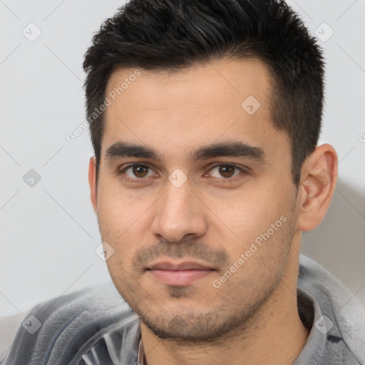 Joyful white young-adult male with short  black hair and brown eyes