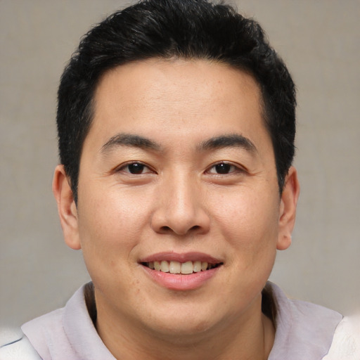 Joyful latino young-adult male with short  brown hair and brown eyes