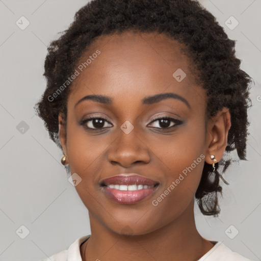 Joyful black young-adult female with long  brown hair and brown eyes