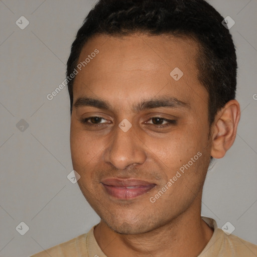 Joyful white young-adult male with short  black hair and brown eyes