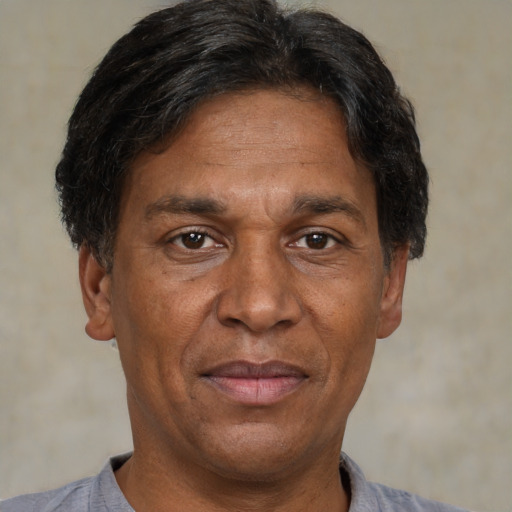 Joyful white adult male with short  black hair and brown eyes
