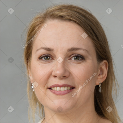 Joyful white adult female with medium  brown hair and grey eyes