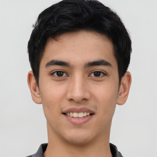 Joyful latino young-adult male with short  brown hair and brown eyes