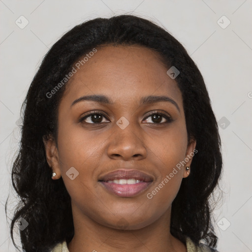 Joyful black young-adult female with long  brown hair and brown eyes