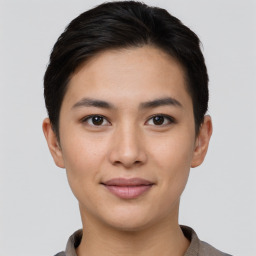 Joyful asian young-adult female with short  brown hair and brown eyes