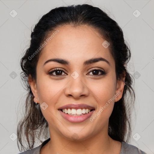 Joyful latino young-adult female with medium  brown hair and brown eyes