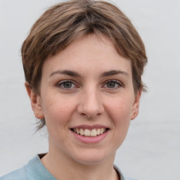 Joyful white young-adult female with short  brown hair and grey eyes