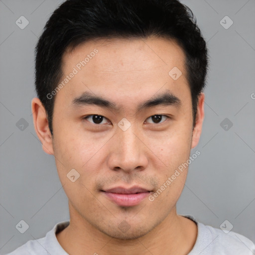 Joyful asian young-adult male with short  black hair and brown eyes