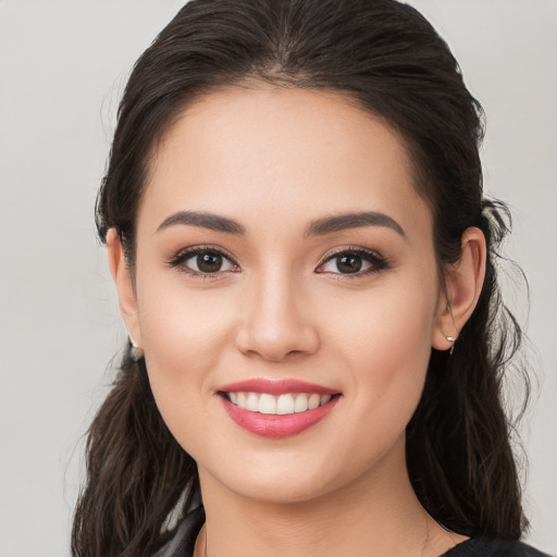 Joyful white young-adult female with long  brown hair and brown eyes