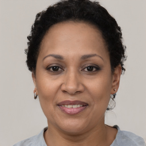 Joyful latino adult female with short  brown hair and brown eyes