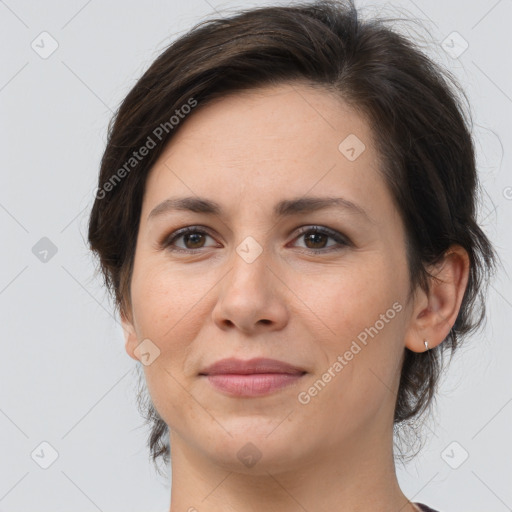 Joyful white adult female with medium  brown hair and brown eyes