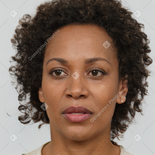 Joyful black adult female with medium  brown hair and brown eyes