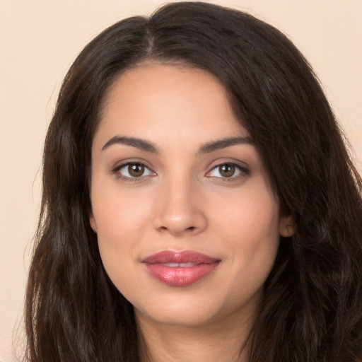 Joyful white young-adult female with long  brown hair and brown eyes