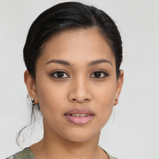 Joyful latino young-adult female with medium  brown hair and brown eyes