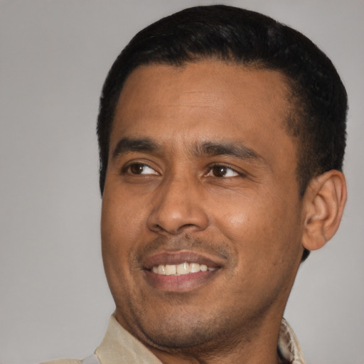 Joyful latino young-adult male with short  black hair and brown eyes
