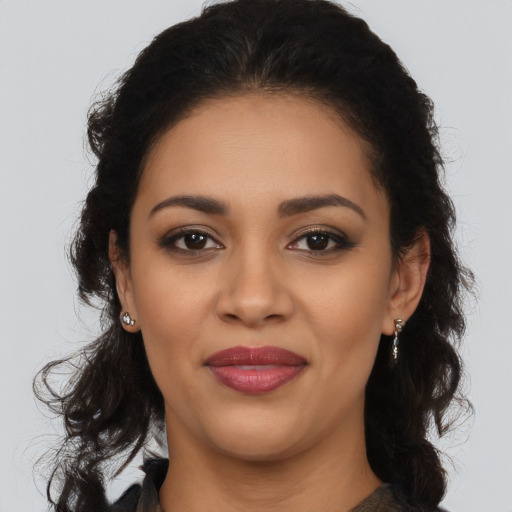 Joyful latino young-adult female with long  brown hair and brown eyes