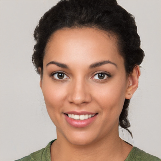 Joyful white young-adult female with short  black hair and brown eyes