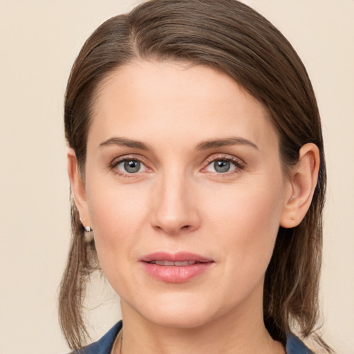 Joyful white young-adult female with medium  brown hair and grey eyes