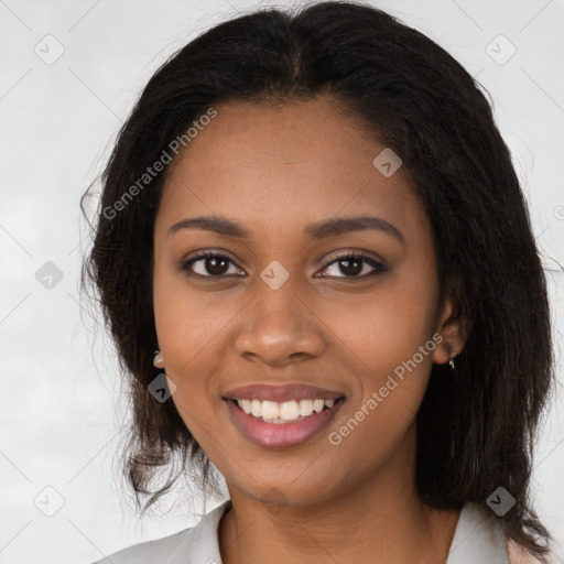 Joyful black young-adult female with long  brown hair and brown eyes