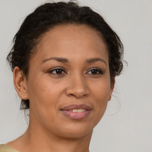 Joyful latino adult female with short  brown hair and brown eyes