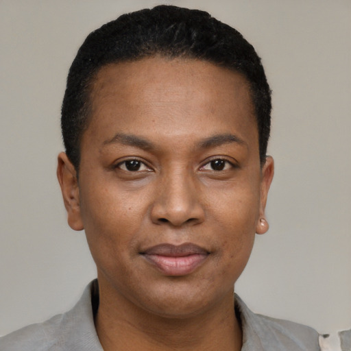 Joyful black young-adult female with short  black hair and brown eyes