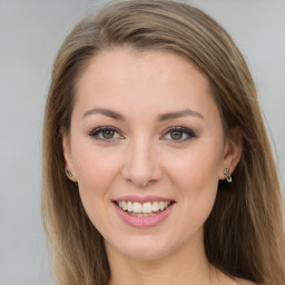 Joyful white young-adult female with long  brown hair and green eyes