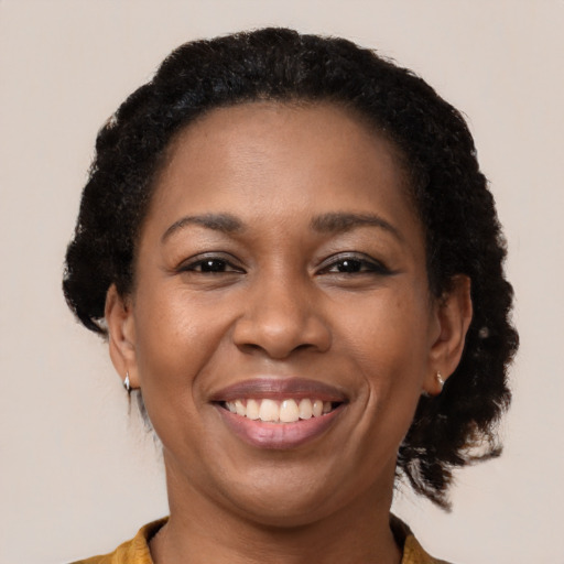 Joyful black young-adult female with medium  brown hair and brown eyes