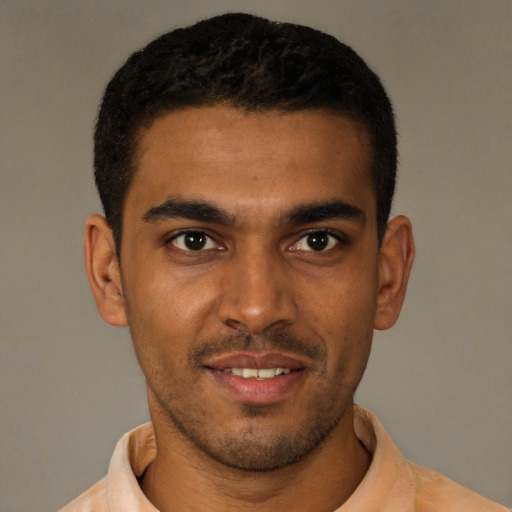 Joyful black young-adult male with short  black hair and brown eyes