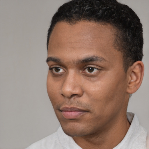 Neutral latino young-adult male with short  black hair and brown eyes