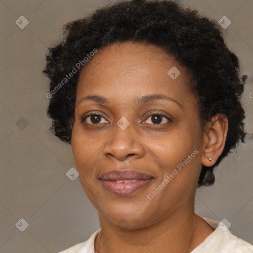 Joyful black adult female with short  brown hair and brown eyes