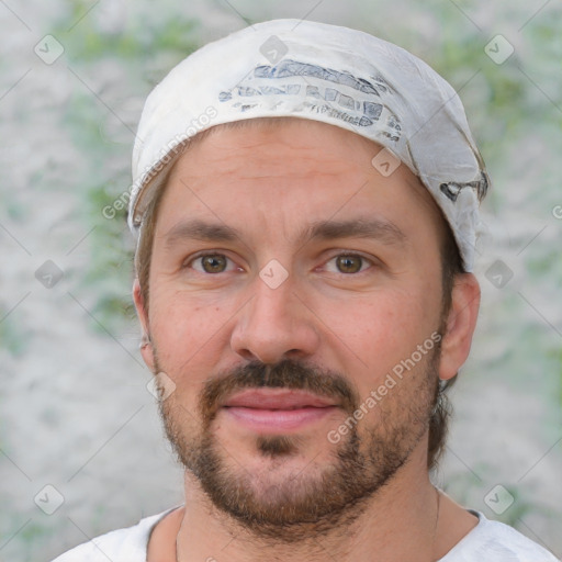 Joyful white adult male with short  black hair and brown eyes