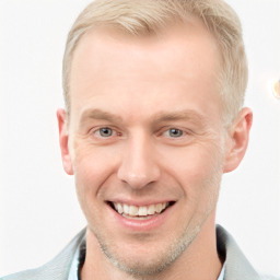 Joyful white adult male with short  brown hair and blue eyes