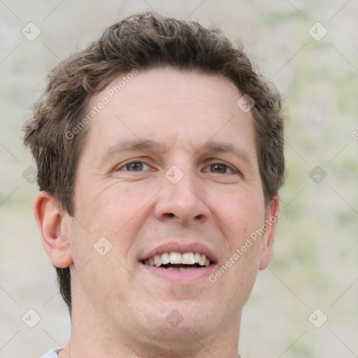 Joyful white adult male with short  brown hair and grey eyes