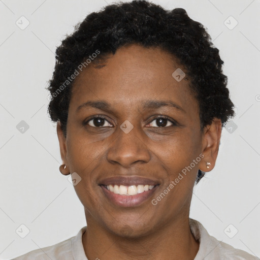 Joyful black young-adult female with short  black hair and brown eyes