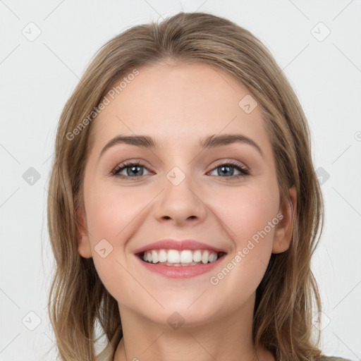 Joyful white young-adult female with long  brown hair and green eyes