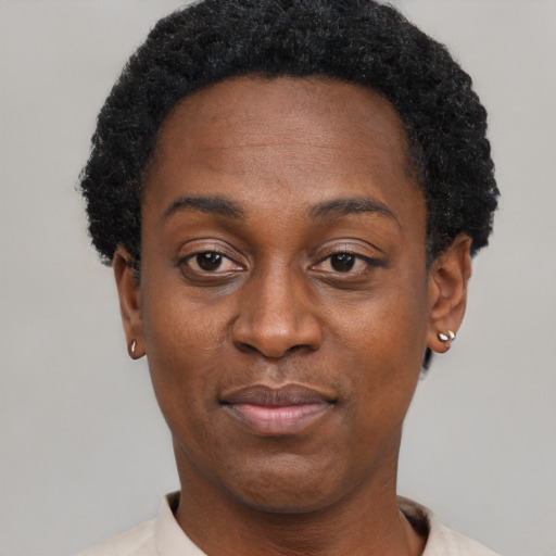 Joyful black adult female with short  black hair and brown eyes