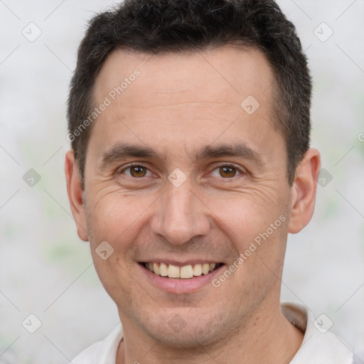 Joyful white adult male with short  brown hair and brown eyes