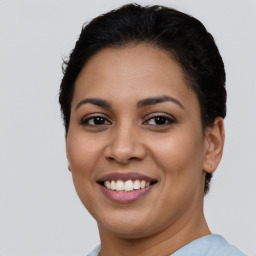 Joyful latino young-adult female with short  brown hair and brown eyes