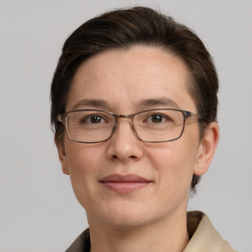 Joyful white adult female with short  brown hair and grey eyes