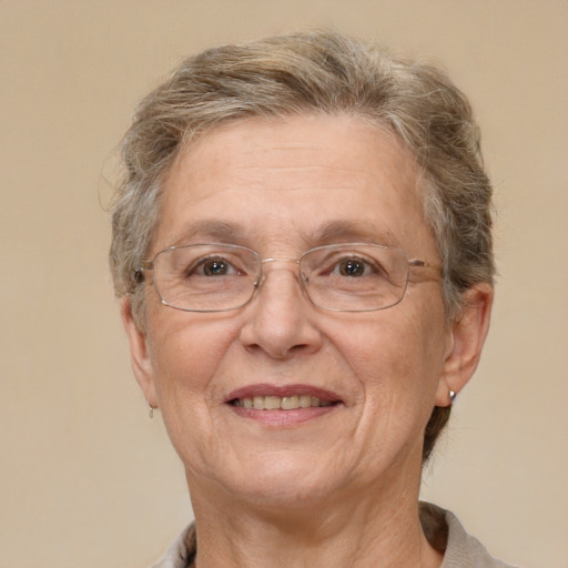 Joyful white middle-aged female with short  gray hair and brown eyes