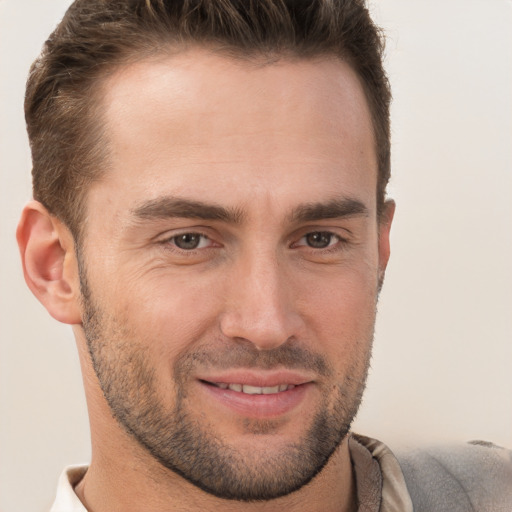 Joyful white young-adult male with short  brown hair and brown eyes