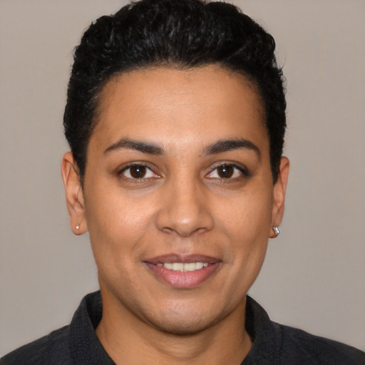 Joyful latino young-adult female with short  black hair and brown eyes