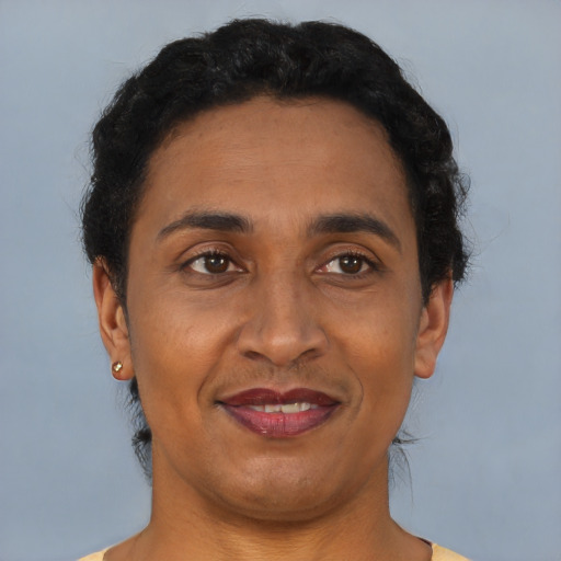 Joyful latino adult male with short  brown hair and brown eyes