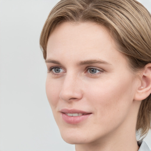 Joyful white young-adult female with medium  brown hair and blue eyes