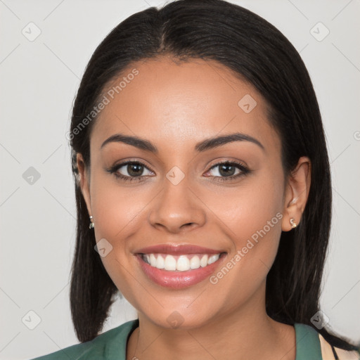 Joyful latino young-adult female with long  brown hair and brown eyes