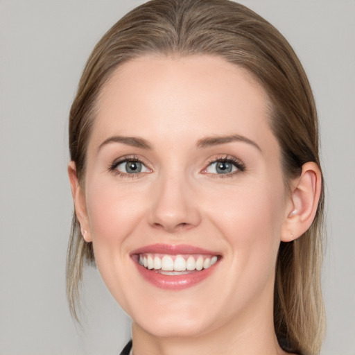 Joyful white young-adult female with medium  brown hair and blue eyes