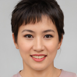 Joyful asian young-adult female with short  brown hair and brown eyes