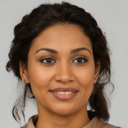 Joyful latino young-adult female with medium  brown hair and brown eyes