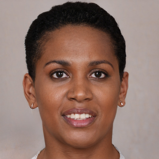 Joyful black young-adult female with short  brown hair and brown eyes